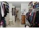 Functional walk-in closet with storage cabinets, shelves, and accessory organization at 4528 Hunt Master Ct, Indianapolis, IN 46268