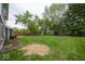 Well-maintained backyard featuring green grass, mature trees, a garden bed, and a small storage shed at 506 Deerberry Dr, Noblesville, IN 46062
