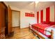 Bedroom with hardwood floors and red and white striped accent wall with Indiana University decor at 506 Deerberry Dr, Noblesville, IN 46062