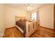 Bedroom with hardwood floors, light walls, a light wood frame bed, and a ceiling fan at 506 Deerberry Dr, Noblesville, IN 46062