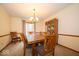 Warm dining room with wood table, cushioned chairs, and a china cabinet at 506 Deerberry Dr, Noblesville, IN 46062