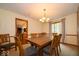 Open dining room with a wood table set, view to kitchen, and neutral decor at 506 Deerberry Dr, Noblesville, IN 46062