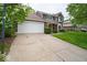 Two-story home with an attached two-car garage, red front door, and well-maintained lawn at 506 Deerberry Dr, Noblesville, IN 46062