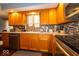 Sun-lit kitchen featuring granite countertops, wood cabinets, tile backsplash, and stainless steel appliances at 506 Deerberry Dr, Noblesville, IN 46062