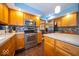 This open kitchen features stainless steel appliances, wood cabinets, and access to other living spaces at 506 Deerberry Dr, Noblesville, IN 46062