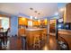 Traditional kitchen offers wood cabinets, stylish backsplash, and an island with bar seating at 506 Deerberry Dr, Noblesville, IN 46062