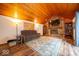 Cozy living room with wood-paneled ceiling, brick fireplace, built-in shelving, and plush seating at 506 Deerberry Dr, Noblesville, IN 46062