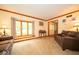 Spacious living room with neutral carpeting, a large window, and comfortable seating area at 506 Deerberry Dr, Noblesville, IN 46062