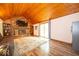 Comfortable living area includes a brick fireplace, wood ceiling, and sliding doors for outdoor access at 506 Deerberry Dr, Noblesville, IN 46062
