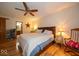 Spacious main bedroom with hardwood floors, a ceiling fan, and a glimpse into the attached bathroom at 506 Deerberry Dr, Noblesville, IN 46062