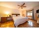 Serene primary bedroom with hardwood floors, ceiling fan, and ample natural light from the window at 506 Deerberry Dr, Noblesville, IN 46062