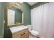 Charming bathroom featuring a stylish vanity, gold fixtures, and wainscoting at 5073 St Charles Pl, Carmel, IN 46033