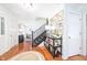 Foyer with dark staircase, hardwood floors, area rug, and decorative console table at 5073 St Charles Pl, Carmel, IN 46033