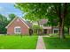 Traditional brick home with a lush front yard and mature trees, offering classic curb appeal at 5073 St Charles Pl, Carmel, IN 46033