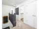 Upstairs hallway leading to a bathroom with neutral carpet and white doors at 5073 St Charles Pl, Carmel, IN 46033