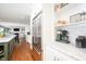 Open kitchen with stainless steel refrigerator and built-in shelving at 5073 St Charles Pl, Carmel, IN 46033