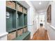 Mudroom with built-in storage, wooden bench, and hardwood floors at 5073 St Charles Pl, Carmel, IN 46033