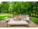 Charming patio featuring a stone fire pit, outdoor seating, and lush greenery, perfect for relaxation at 5073 St Charles Pl, Carmel, IN 46033