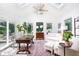 Bright sunroom with vaulted ceilings, skylights, brick floor, and ample seating at 5073 St Charles Pl, Carmel, IN 46033