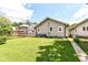 Spacious backyard with lush green grass, mature trees, and a well-maintained lawn at 518 N Emerson Ave, Indianapolis, IN 46219