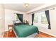 Serene bedroom with hardwood floors, natural light, and a comfortable bed, creating a peaceful retreat at 518 N Emerson Ave, Indianapolis, IN 46219