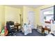 Small yellow bedroom, with a small desk and chair that offers a peaceful and comfortable space at 518 N Emerson Ave, Indianapolis, IN 46219