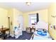 Cozy bedroom with a single bed, desk, and ample natural light, perfect for relaxing and resting at 518 N Emerson Ave, Indianapolis, IN 46219