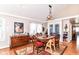 Elegant dining room with hardwood floors, natural light, and a classic dining set, ideal for Gathering gatherings at 518 N Emerson Ave, Indianapolis, IN 46219