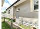 Exterior view features well-maintained siding and a fenced yard for privacy and security at 518 N Emerson Ave, Indianapolis, IN 46219