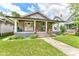 Charming home with a welcoming front porch, well-maintained lawn, and red railing, blending character and curb appeal at 518 N Emerson Ave, Indianapolis, IN 46219