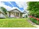 Charming two-story home with a welcoming front porch and well-manicured lawn and garden at 518 N Emerson Ave, Indianapolis, IN 46219