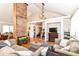 Bright living room featuring a brick accent column, fireplace, and hardwood floors at 518 N Emerson Ave, Indianapolis, IN 46219