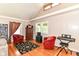 Bright living room with hardwood floors, high ceilings, large windows, and a stylish front door at 518 N Emerson Ave, Indianapolis, IN 46219