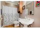 Bathroom boasts a pedestal sink, vanity mirror and a shower with decorative curtains at 5251 Apache Moon, Carmel, IN 46033