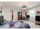 Carpeted bedroom with overhead lighting, chair, desk, bookcase, and a walk-in closet at 5251 Apache Moon, Carmel, IN 46033