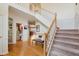 Grand foyer featuring a staircase, hardwood floors, and views of the living spaces at 5251 Apache Moon, Carmel, IN 46033