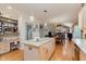 Bright kitchen with an island, light wood cabinets, and an open layout to the living areas at 5251 Apache Moon, Carmel, IN 46033