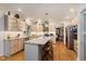 Bright kitchen featuring custom cabinets, stone countertops, stainless appliances, and a large center island with seating at 5251 Apache Moon, Carmel, IN 46033