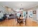 Open-concept living and dining area with vaulted ceilings, fireplace and hardwood flooring at 5251 Apache Moon, Carmel, IN 46033