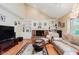 Cozy living room with a fireplace, built-in bookshelves, and comfortable seating at 5251 Apache Moon, Carmel, IN 46033