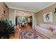 Cozy living room showcasing a decorative rug, grand piano, light-colored sofa, and access to the dining room at 5251 Apache Moon, Carmel, IN 46033