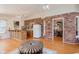 Relaxing living room with brick accent wall, wet bar, and hardwood floors perfect for entertaining at 5251 Apache Moon, Carmel, IN 46033