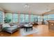Bright sunroom featuring hardwood floors, large windows, and comfortable seating perfect for relaxation at 5251 Apache Moon, Carmel, IN 46033
