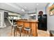 Basement bar featuring a wooden bar, stools, and a black refrigerator at 5758 N 900 W, Thorntown, IN 46071