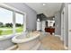 This bathroom has a standalone soaking tub, large window with great views, and separate vanities at 5758 N 900 W, Thorntown, IN 46071