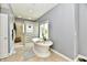 Bright bathroom featuring a standalone soaking tub and separate shower with glass block enclosure at 5758 N 900 W, Thorntown, IN 46071