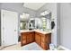 Bathroom features an extended vanity with double sinks, a large mirror, and contemporary lighting at 5758 N 900 W, Thorntown, IN 46071