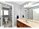 Bathroom features a wood vanity, a large mirror, and an entrance to a tiled walk-in shower at 5758 N 900 W, Thorntown, IN 46071