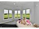 Bright bedroom with bay windows overlooking serene views, featuring a beanbag chair for a relaxing space at 5758 N 900 W, Thorntown, IN 46071