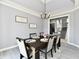 Dining room boasts a modern chandelier, decorative wall hangings, and nearby access to the staircase at 5758 N 900 W, Thorntown, IN 46071